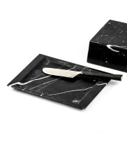 Black marble butter dish with open lid and butter knife