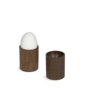 2 dark brown wooden egg cups one with egg