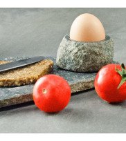 Stone egg holder with egg and plate with tomato