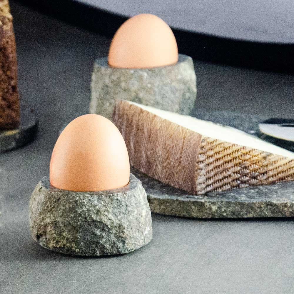 2 stone egg holders with egg and cheese plate