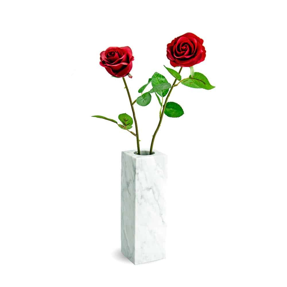 Modern vase made of white marble in angular shape decorated with red roses