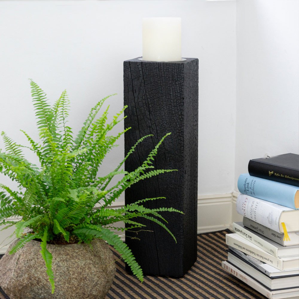 Black candle holder LUNA 55 in yakisugi refined decorated with planter and stack of books