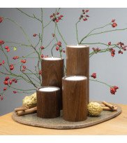 Set of 4 tea light holders STUV made of smoked oak with large tea lights decorated with nuts and rosehip twigs