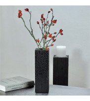 Angular black oak vase finished in Yakisugi with glass insert and rosehip branch decoration